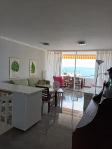 a living room with a view of the ocean at Great oportunity Costa Adeje Holiday apartment first sea line Free Wifi in Callao Salvaje