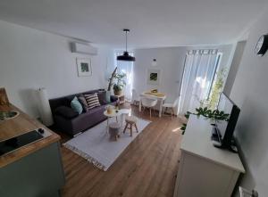 a living room with a couch and a table at Casa 39 Apartments in Rovinj