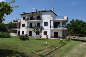 a large white building with a yard in front of it at Lucid Dream Apt. Bozinis 2 in Psakoudia
