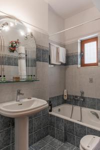 a bathroom with a sink and a bath tub at Bolero Apartment Argostoli in Argostoli