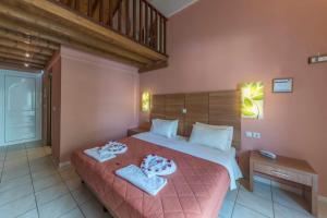 een slaapkamer met een groot bed en 2 handdoeken bij Anassa Hotel in Skála Kefalonias