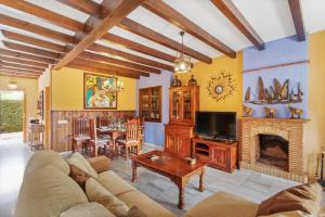 salon z kanapą i kominkiem w obiekcie Villa estilo mediterránea con Piscina, Jardín, Bbq y Jacuzzi - VILLA BEL AIR REAL w mieście Estepona