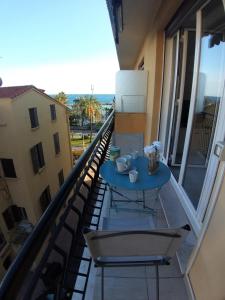 a balcony with a blue table and chairs on it at Gabriella in Menton