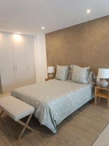 a bedroom with a large bed with a wooden headboard at Rooms & Suites Loft 2F Deluxe Edition Arrecife in Arrecife