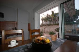 a bowl of fruit on a table in a kitchen at Apartment Džoni in Split