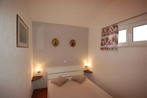 a bedroom with a bed with two pillows on it at Apartment Džoni in Split