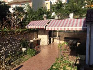 a brick building with a red and white awning at Apartment Džoni in Split