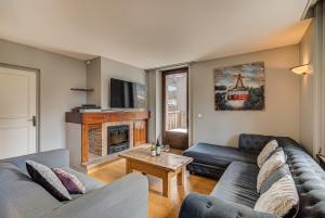 a living room with two couches and a fireplace at APARTMENT PRESIDENT - Alpes Travel - Central Chamonix - Sleeps 12 in Chamonix-Mont-Blanc