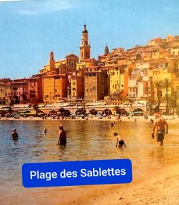 a group of people in the water at a beach at Gabriella in Menton