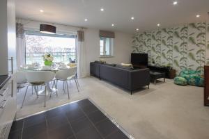 a living room with a couch and a table at Howells Mere 88, Tranquility P in Somerford Keynes
