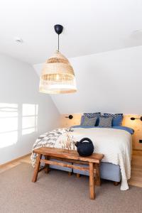 a bedroom with a bed and a wooden bench at HomeSweetHome in Üksnurme