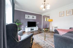 salon z kanapą i telewizorem w obiekcie Dwellers Delight Living Ltd Serviced Accommodation, Chigwell, London 3 bedroom House, Upto 7 Guests, Free Wifi & Parking w Londynie