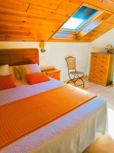 um quarto com uma cama grande e uma clarabóia em Duplex Playa de Rons em O Grove