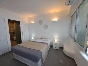 A bed or beds in a room at Dreaming View Suites