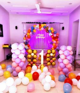 a room with a bunch of balloons and a number one sign at KshiyOO Holiday Bungalow Resort in Pune