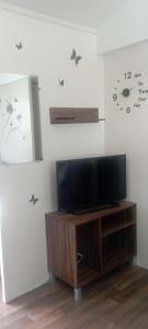 a flat screen tv sitting on top of a wooden entertainment center at Mobil-home Aventura 3 par Catherve in Canet-en-Roussillon