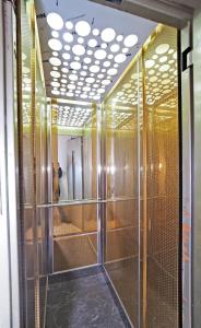 a dressing room with glass doors and a mirror at Arges old city hotel in Istanbul