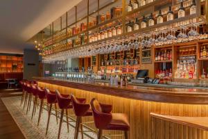 a bar with a row of chairs in a room at Hyatt Centric The Liberties Dublin in Dublin