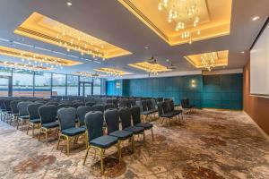 a conference room with rows of chairs and a screen at Hyatt Centric The Liberties Dublin in Dublin