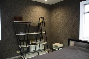 a bedroom with a book shelf next to a bed at Квартира лофт-стиль in Konotop