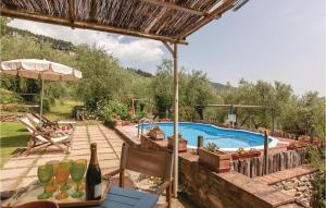 a patio with a pool and a table with wine bottles at Lolivo in Buti