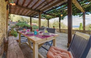 a wooden table and chairs under a wooden pergola at Lolivo in Buti