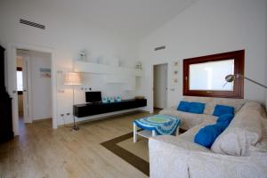 a living room with a couch and a table at Villa Franca by Wonderful Italy in San Teodoro