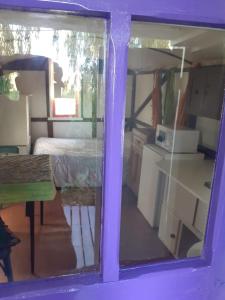 uma vista para um quarto com uma cama e uma janela em Casa Vagón en las sierras em Tandil
