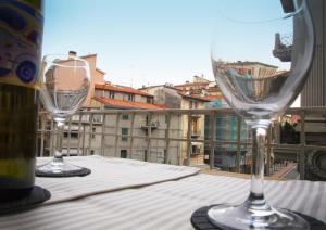 two wine glasses sitting on a table on a balcony at La Cittadella in La Spezia
