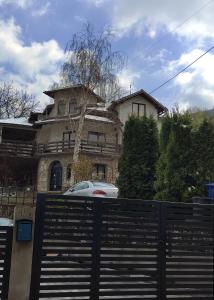 a house with a car parked in front of it at Apartman Borići in Soko Banja