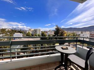 a balcony with a table and chairs and a view at Quiet and Cozy Apartment of New Psihiko No 6 in Athens