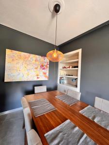 a dining room with a wooden table and a map at Quiet and Cozy Apartment of New Psihiko No 6 in Athens