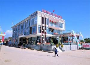 a man walking in front of a building on the beach at Central Ly Son in Ly Son