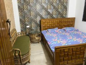 a bedroom with a bed and two baskets and a chair at Fancy and Modern Apartment in Patna