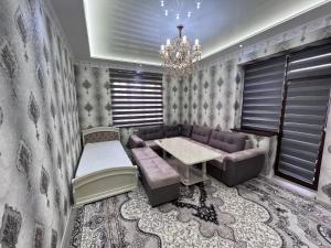 a living room with a couch and a table at COMFORT iNN 2 in Samarkand