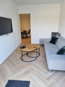 a living room with a couch and a table at Calm Down Near The Sea in Vlissingen