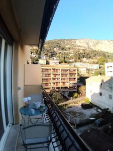 a balcony with a table and chairs and a building at Gabriella in Menton