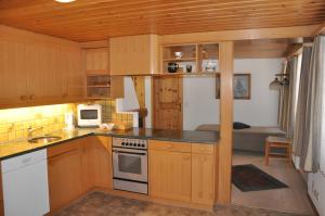 a kitchen with a sink and a stove top oven at FERIENWOHNUNGEN Chalet Hohturnen in Grindelwald