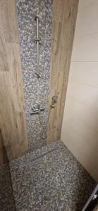 a bathroom with a shower with a cross on the wall at Family apartment 2 rooms in Kharkiv