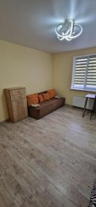 a living room with a couch in the middle of a room at Family apartment 2 rooms in Kharkiv