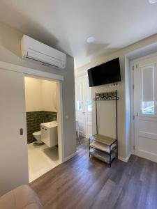 a room with a bathroom with a sink and a mirror at Centro da Vila in Ponte de Lima +51 photos