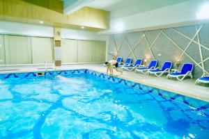 a person is standing in a swimming pool at Circle Club Faisalabad in Faisalabad
