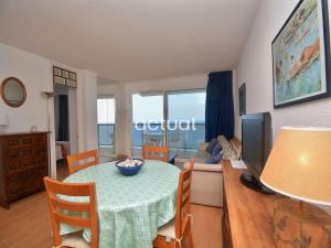 a living room with a table and a couch at President B-14 in Platja d'Aro