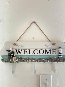a welcome sign is hanging on a wall at 1 BR, Dorado beach apartment 20% monthly discount in Dorado