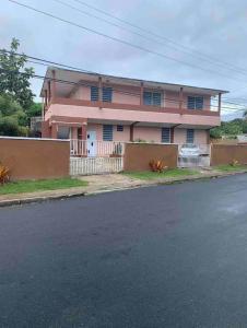 a pink house on the side of a street at 1 BR, Dorado beach apartment 20% monthly discount in Dorado