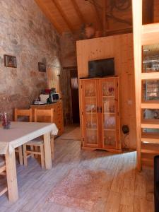 a living room with a table and a kitchen at Carregã Water mill in Penela