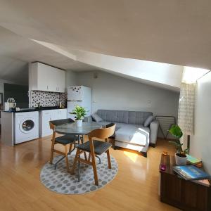 a kitchen and a living room with a table and chairs at Cosy & Spacious Terrace Flat in Istanbul