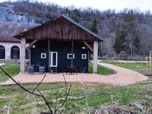 a barn with a picnic table in front of it at Best Price #A "LA REMISE" x4 people in Lods
