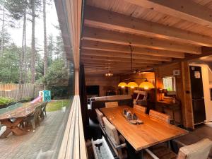 a wooden house with a table on a deck at Casa Delux in Lille