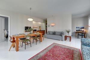 a kitchen and living room with a table and chairs at Downtown Apartments Riverside & Parking Szafarnia Street in Gdańsk
